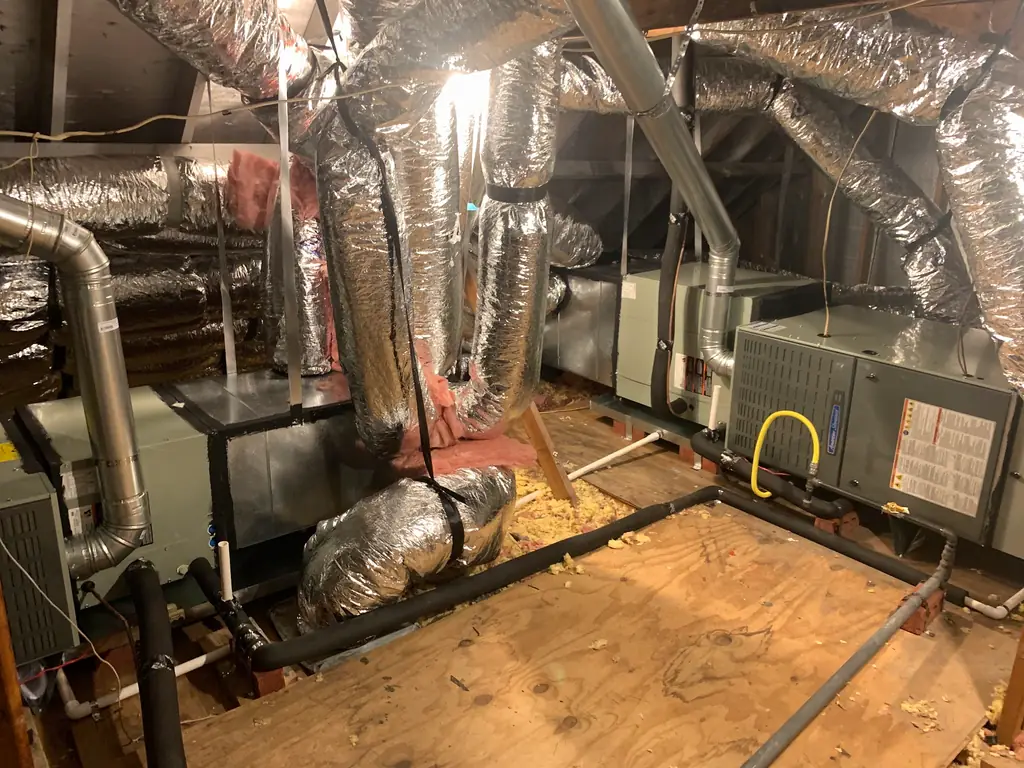 Insulated flex duct runs and air handlers in a Conroe attic